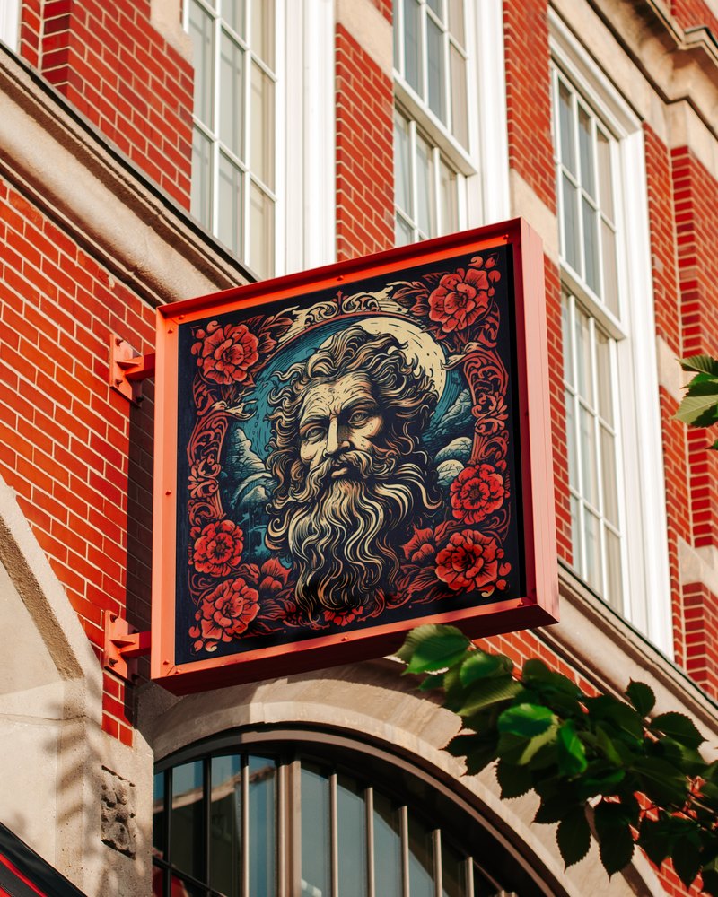 A hanging shop sign illustrated with a bearded figure surrounded by roses, mounted on a brick building