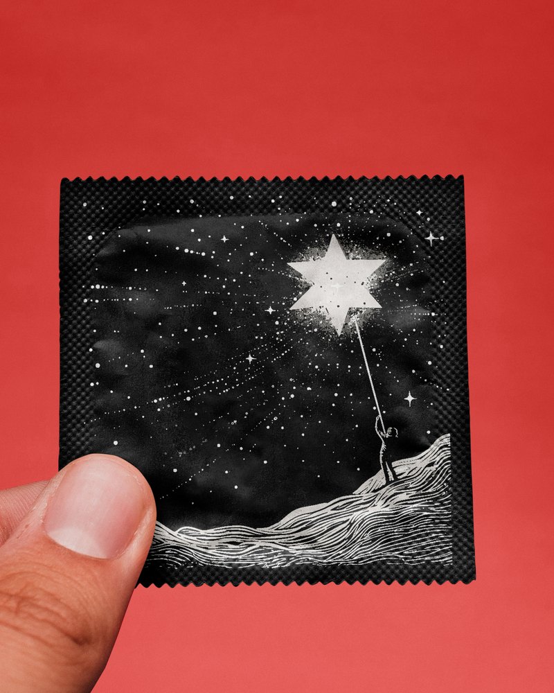 A foil wrapper illustrated with a figure reaching for a star, held between two fingers
