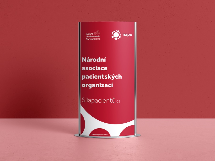A NAPO roll-up banner reading 'Národní asociace pacientských organizací' and 'Síla pacientů.cz', in crimson